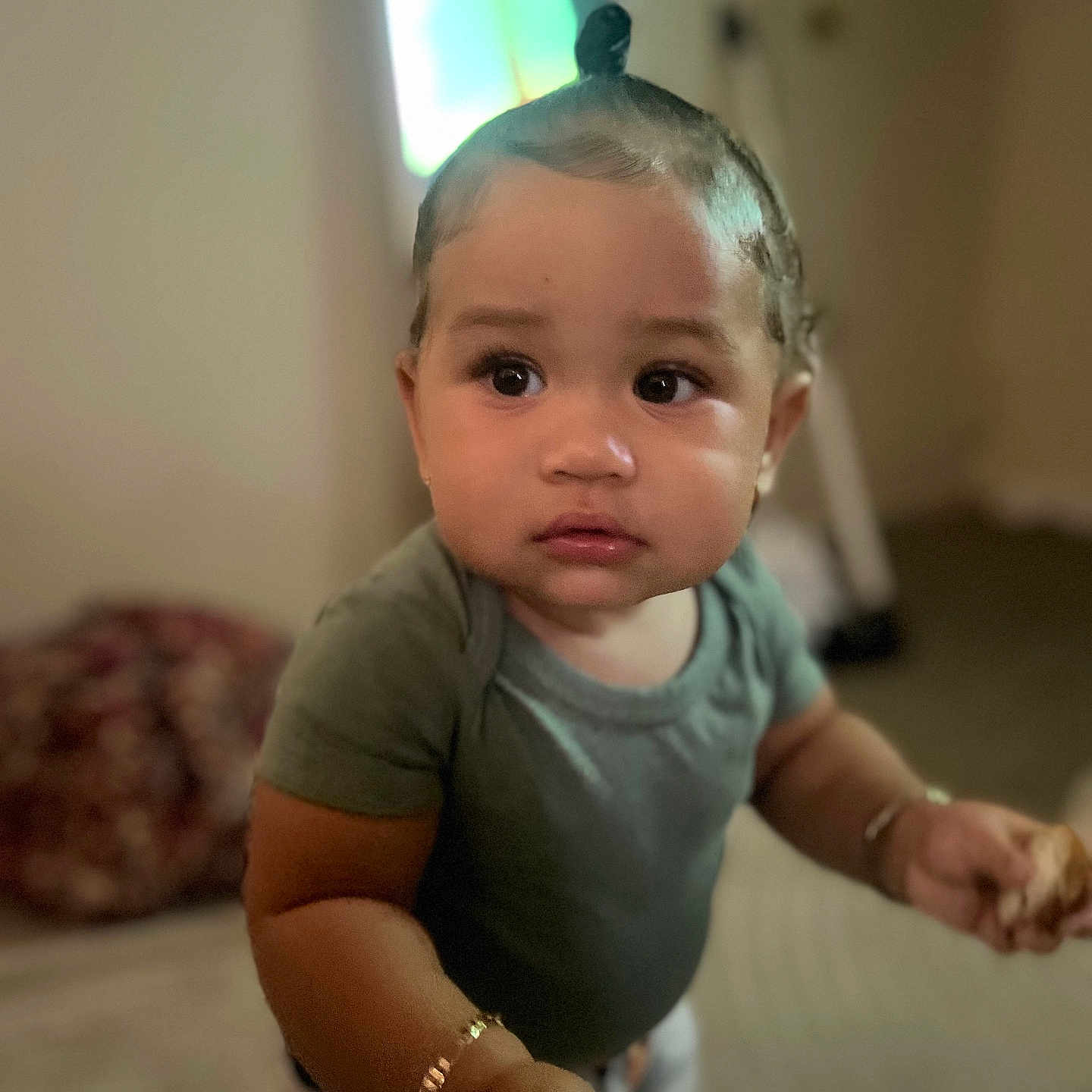 Valettia Sky joined the competition — help win amazing prizes! baby, blurred_background, bracelet, child, curly_hair, cute, expression, face, food, green_shirt, hand, home, indoor, looking_away, person, portrait, skin, standing, toddler, young_child