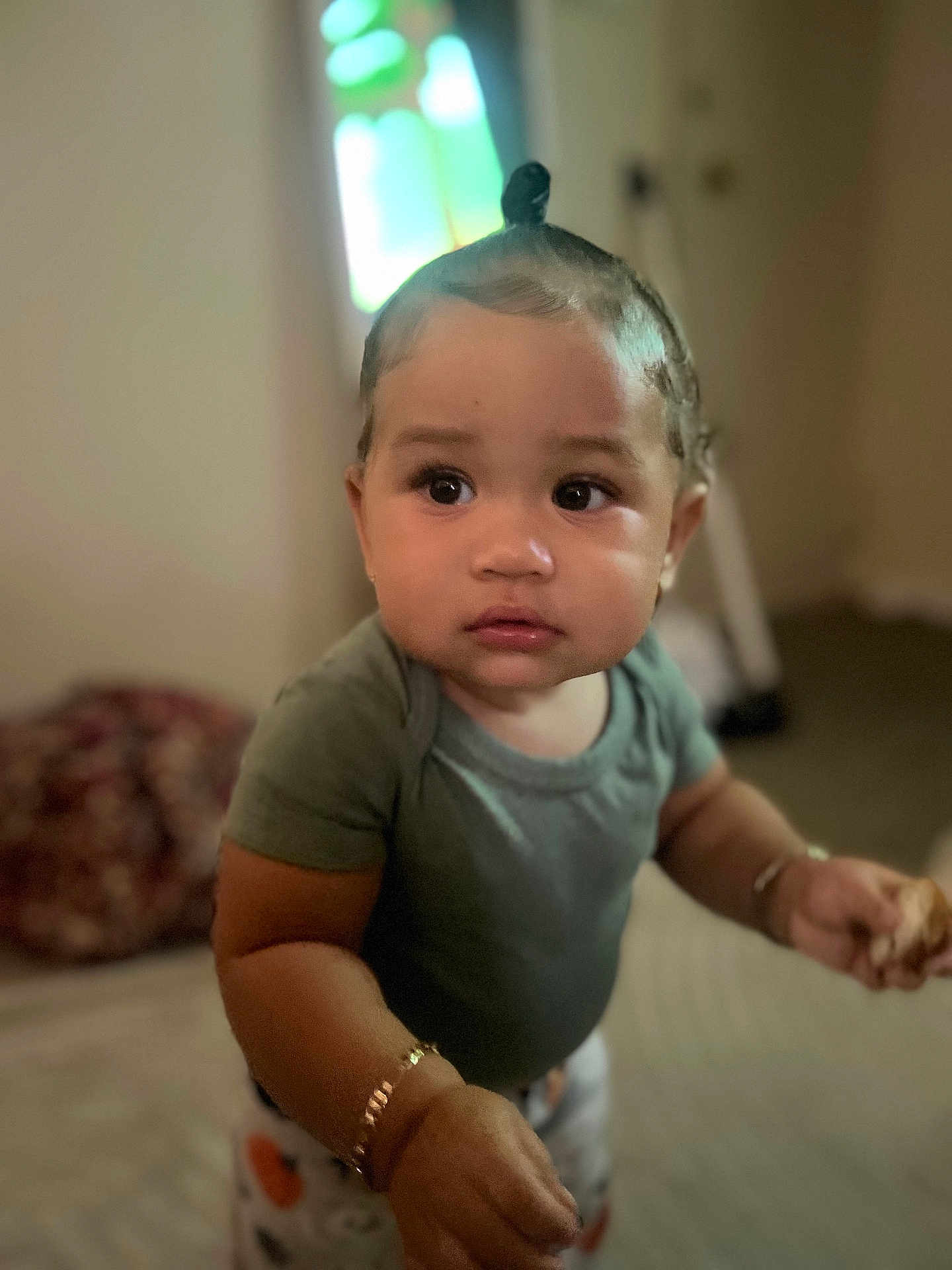 Valettia Sky joined the competition — help win amazing prizes! baby, blurred_background, bracelet, child, curly_hair, cute, expression, face, food, green_shirt, hand, home, indoor, looking_away, person, portrait, skin, standing, toddler, young_child