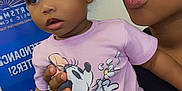 Seven joined the competition — help win amazing prizes! background, carpet, chair, child, clothing, cute, expression, face, hair_bow, hand, holding, indoor, minnie_mouse, pants, person, pink_shirt, playful, portrait, toddler, woman