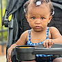 Seven joined the competition — help win amazing prizes! baby, baby_hair, blue_checkered_outfit, child, closeup, cute, hair_clips, hand, outdoor, person, plastic_tray, portrait, seat_belt, serious_face, sitting, skin, stroller, summer, toddler, young_child
