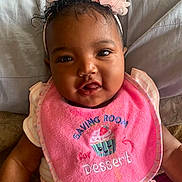 Tru joined the competition — help win amazing prizes! baby, child, pink_bib, flower_headband, smiling, cute, infant, clothing, portrait, sitting, indoors, face, happy, skin, person, headwear, apparel, closeup, young_child, baby_girl