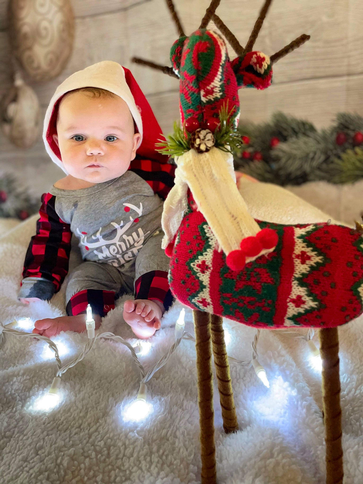 Theo joined the competition — help win amazing prizes! baby, baby_toddler_clothing, christmas, christmas_decoration, christmas_eve, christmas_ornament, costume, costume_hat, event, fawn, fictional_character, happy, hat, headgear, holiday, holiday_ornament, ornament, person, plant, red