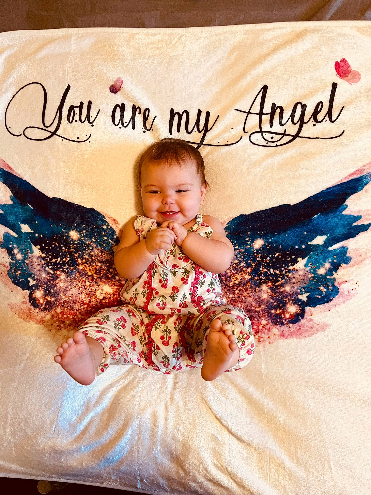 Oaklee is registered to the contest to win money with this photo: baby, baby_toddler_clothing, child, dress, event, face, finger, font, fun, gesture, happy, head, joy, linens, pattern, person, photo_caption, pink, product, smile