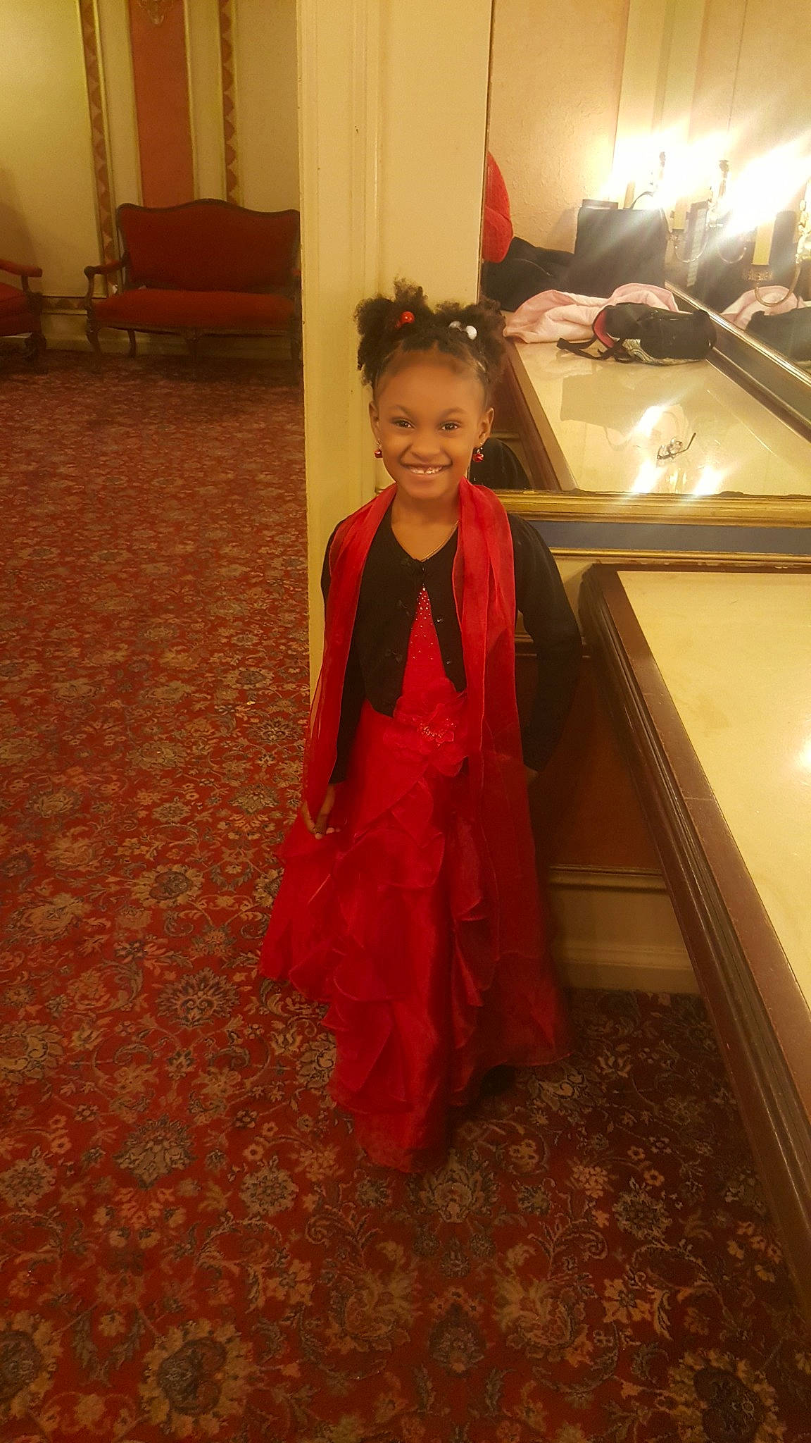 D'Ari is registered to the contest to win money with this photo: beauty, child, clothing, day, dress, facial_expression, flooring, fun, girl, joy, lady, outerwear, person, pink, red, room, sitting, skin, smile, snapshot