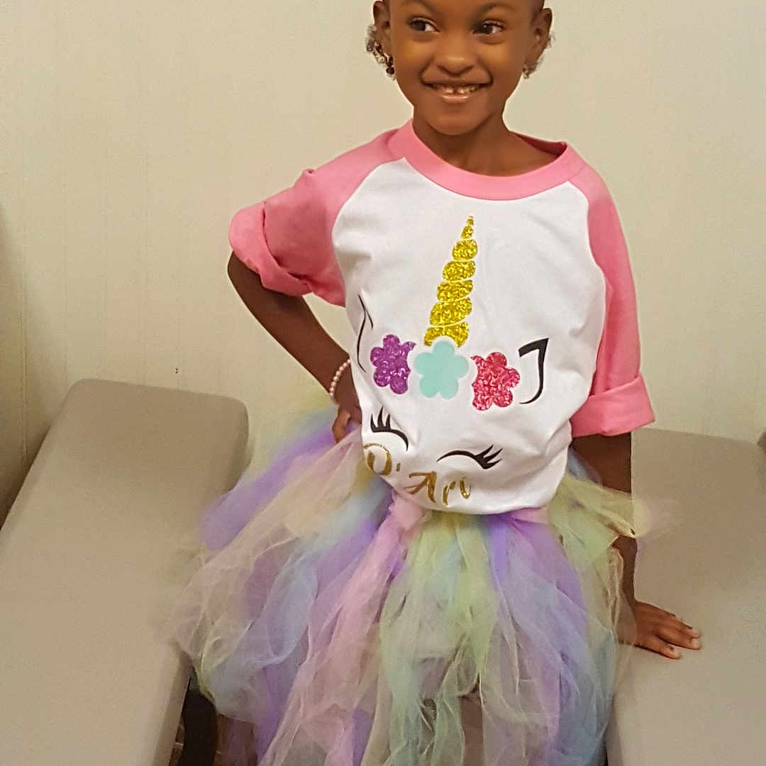 D'Ari is registered to the contest to win money with this photo: ballet_tutu, child, clothing, costume, dance_dress, fun, girl, hair_accessory, joy, person, pink, product, purple, toddler