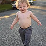 toddler, child, curly_hair, smile, shirtless, pants, shoes, outdoor, street, sunlight, autumn, bokeh, walking, happy, person, daytime, casual, playful, cute, curly