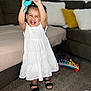 Gleiany joined the competition — help win amazing prizes! toddler, child, white_dress, smiling, indoor, carpet, toy, xylophone, sandal, couch, pillow, living_room, happy, black_sandals, playful, person, furniture, home, cute, joyful