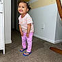 Gleiany joined the competition — help win amazing prizes! child, toddler, smiling, indoor, carpet, striped_shirt, pink_pants, flip_flops, person, happy, hair_buns, earrings, wall, furniture, home, floor, colorful_clothing, cute, standing, portrait