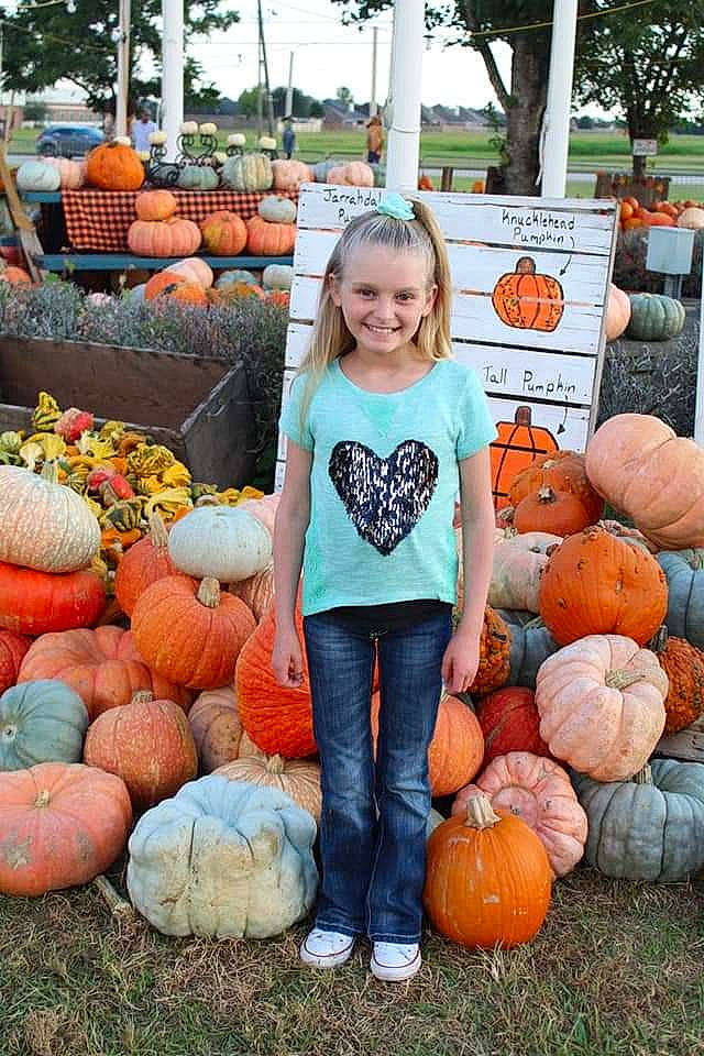 Ashlynn joined the competition — help win amazing prizes! calabaza, cucurbita, food, fruit, gourd, grass, green, joy, local_food, natural_foods, orange, people, person, photograph, plant, pumpkin, smile, squash, staple_food, vegetable
