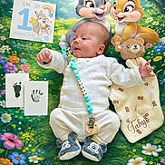 Tahys participe au concours pour gagner de l'argent avec cette photo : baby, baby_clothing, blanket, cartoon, child, colorful, comforter, cute, floral_pattern, footprint, handprint, indoors, infant, lying_down, pacifier_clip, plush_toy, rabbit, smiling, soft, toy