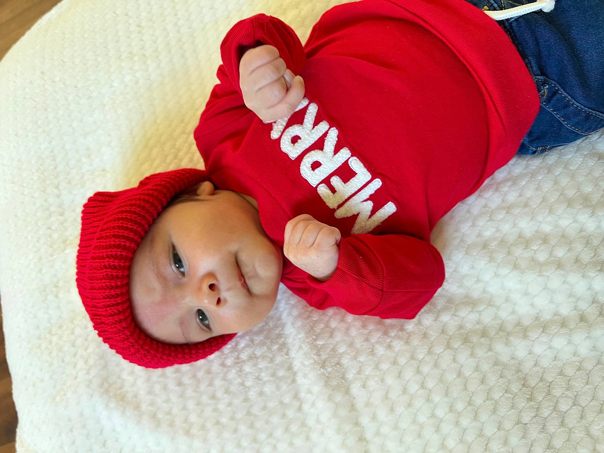 Ace is registered to the contest to win money with this photo: baby, baby_products, baby_sleeping, baby_toddler_clothing, carmine, cheek, child, comfort, foot, hat, headgear, headwear, linens, nap, person, room, sitting, skin, sleeve, toddler