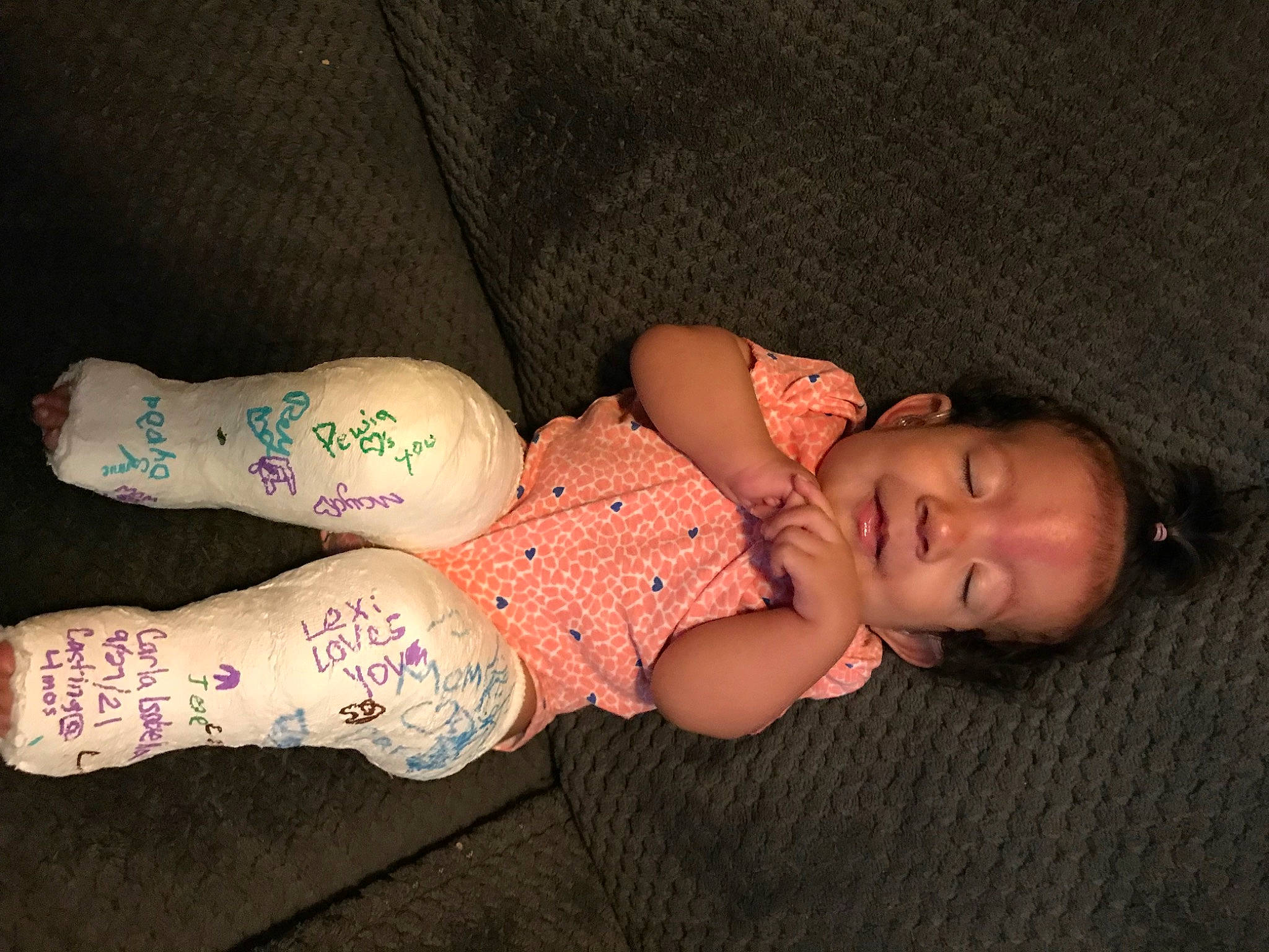 Carla is registered to the contest to win money with this photo: baby, baby_toddler_clothing, chest, comfort, elbow, finger, foot, human_body, human_leg, knee, leg, nail, pattern, person, sleeve, sock, thigh, toddler, trunk, wood