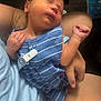 Micah is registered to the contest to win money with this photo: baby, newborn, sleeping, blue_striped_outfit, infant, person, hand, arm, skin, clothing, indoor, closeup, peaceful, cute, resting, young_child, human, holding, toddler, portrait