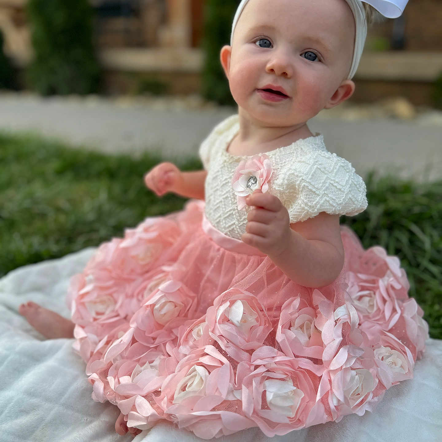 Sterling is registered to the contest to win money with this photo: baby, bodypart, bonnet, clothing, dress, face, fashion, finger, flower, flowerarrangement, flowerbouquet, formalwear, gown, hand, hat, head, person, photography, plant, portrait