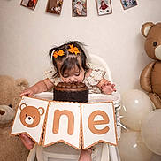 Isabella joined the competition — help win amazing prizes! baby, balloons, banner, birthday, cake, celebration, child, chocolate_cake, cute, decorations, face, girl, happy, high_chair, indoor, milestone_photos, one_year, orange_bows, party, teddy_bear