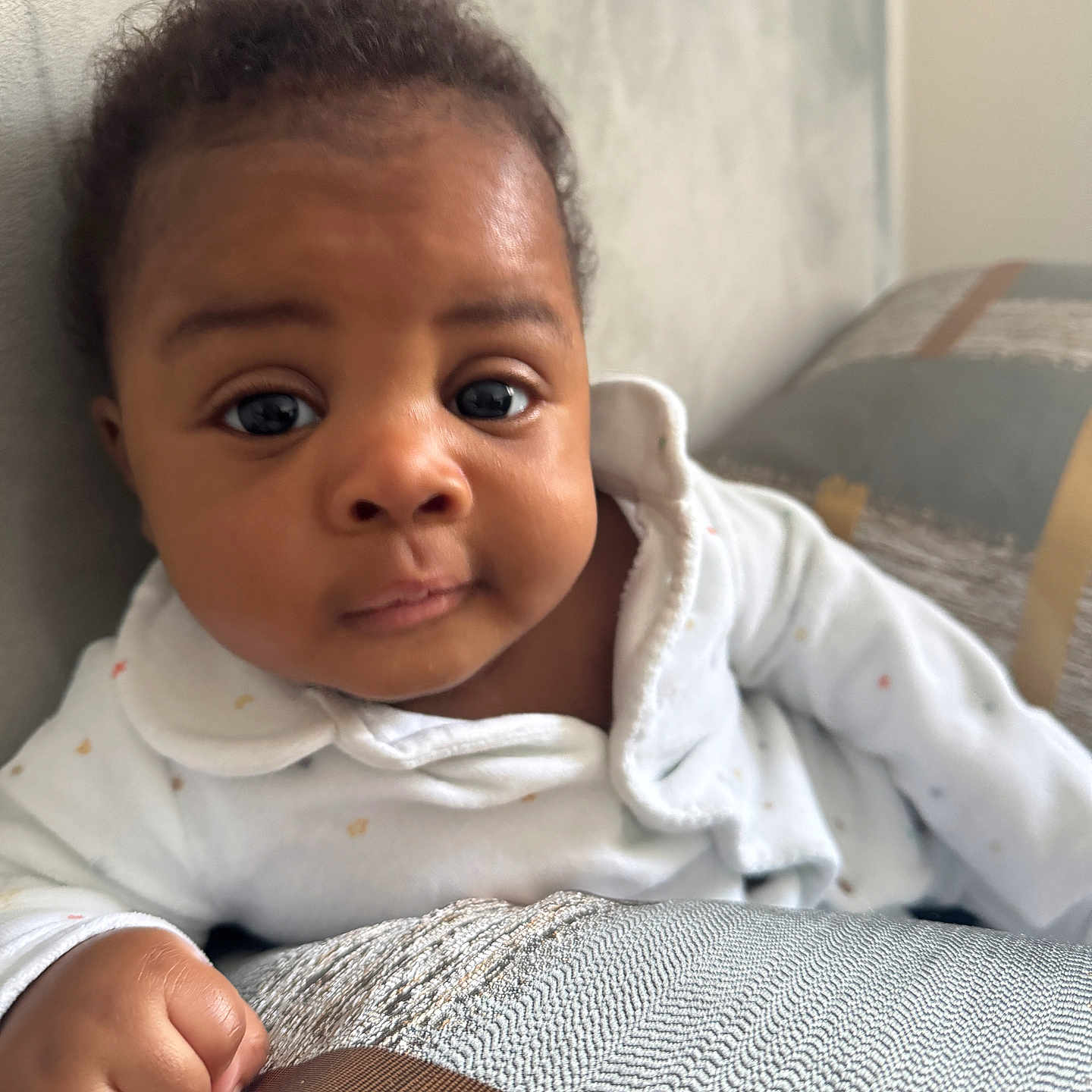 Lloyd joined the competition — help win amazing prizes! baby, blanket, bodypart, clothing, face, finger, hand, happy, head, knitwear, longsleeve, newborn, person, photography, portrait, quilt, sitting, sleeve, smile, sweater