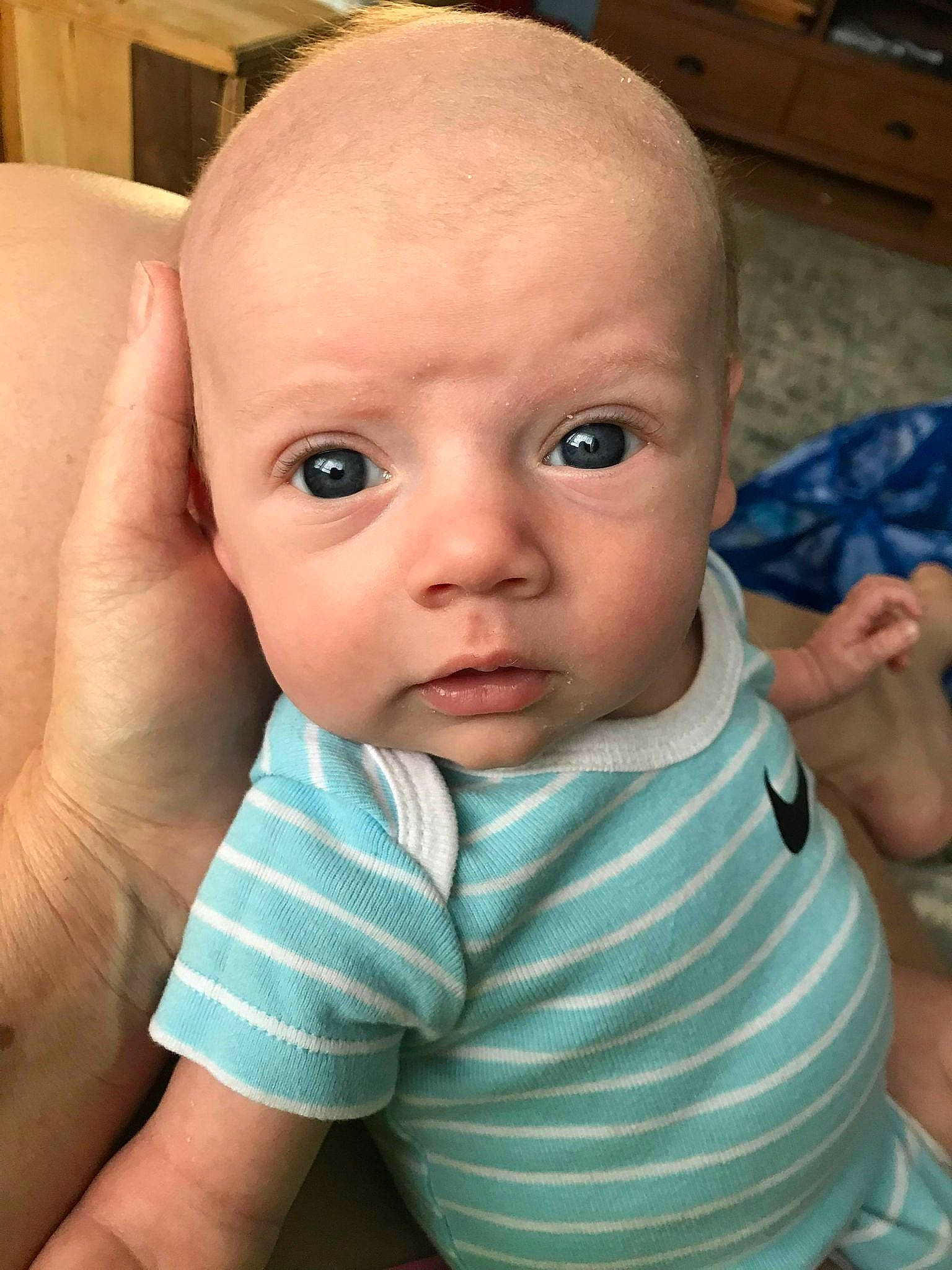 Bryson is registered to the contest to win money with this photo: arm, baby, baby_toddler_clothing, cheek, chin, eye, eyebrow, facial_expression, gesture, hairstyle, hand, head, iris, lip, mouth, neck, nose, person, product, skin