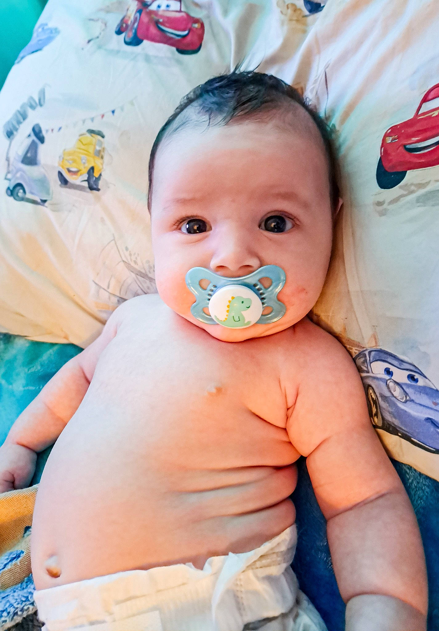 Jax is registered to the contest to win money with this photo: abdomen, azure, baby, baby_products, baby_toddler_clothing, cheek, chest, child, event, happy, iris, linens, person, sitting, skin, toddler, vacation