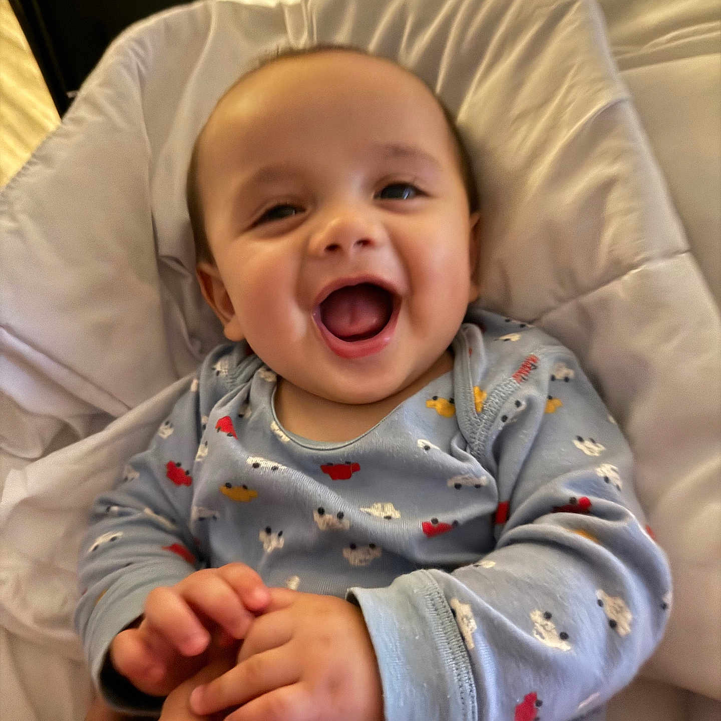 Rayleigh Lucas joined the competition — help win amazing prizes! baby, bed, blanket, child, cozy, cute, expression, face, hand_holding, happy, indoor, infant, joy, laughing, onesie, person, skin, sleepwear, smiling, toddler
