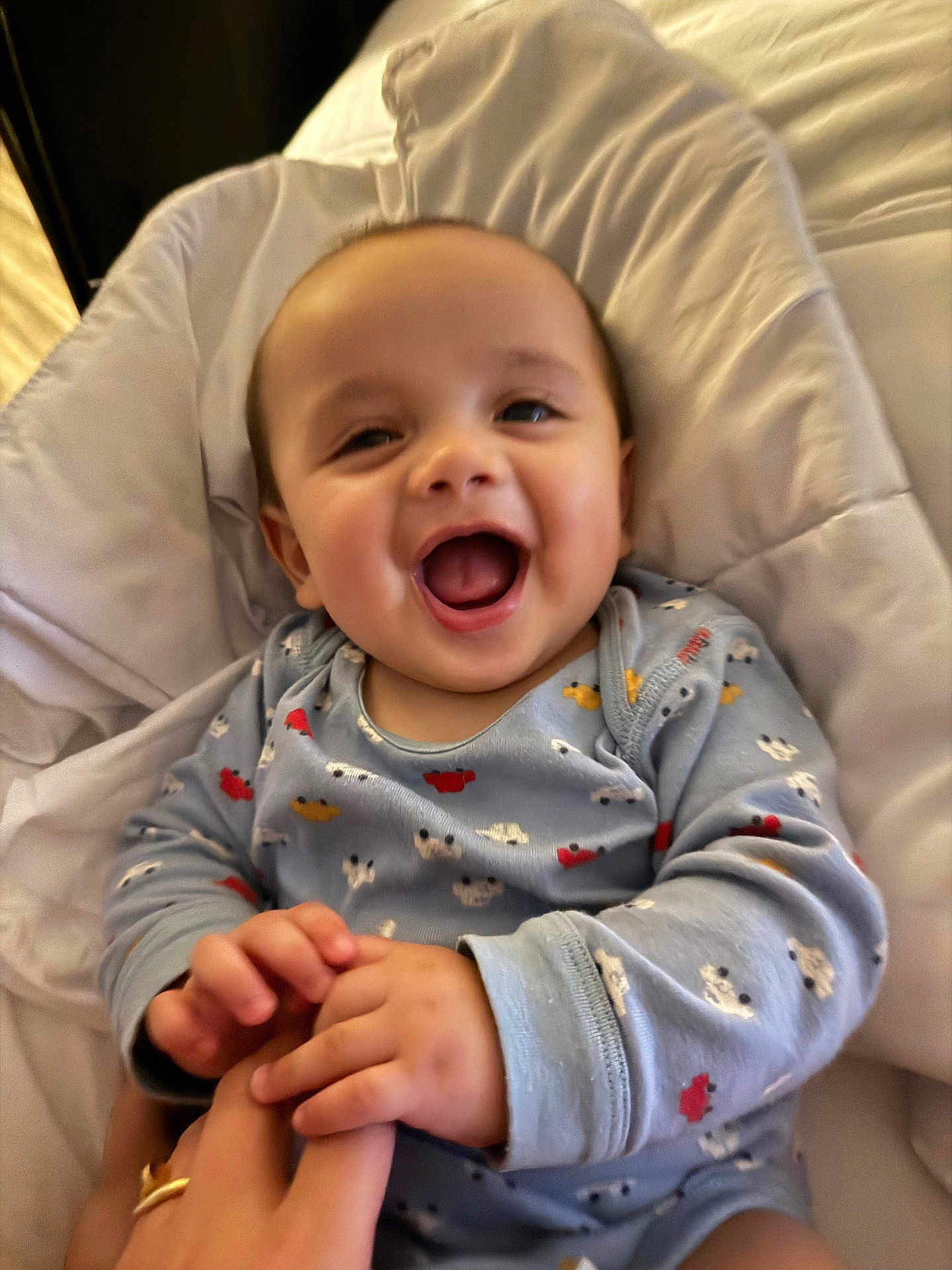 Rayleigh Lucas joined the competition — help win amazing prizes! baby, child, smiling, laughing, onesie, hand_holding, bed, blanket, indoor, happy, cute, infant, person, face, joy, cozy, sleepwear, skin, expression, toddler