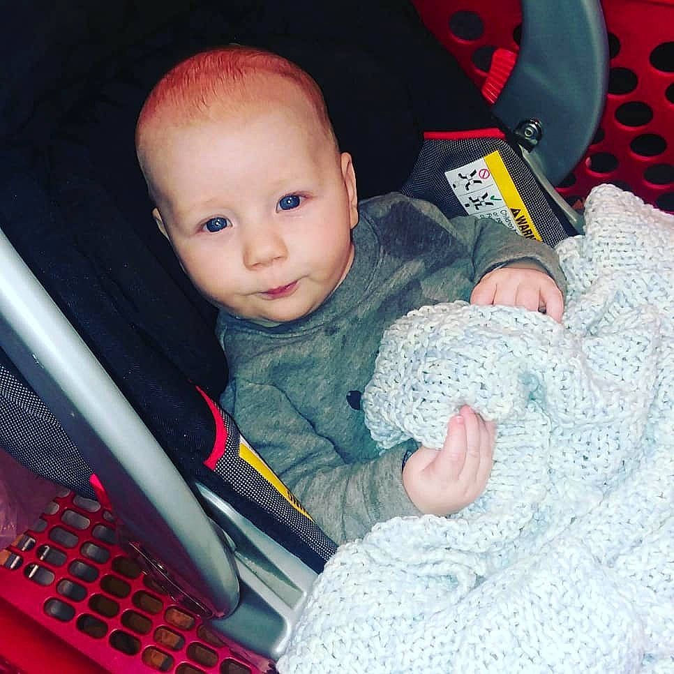 Wrigley is registered to the contest to win money with this photo: boy, car_seat, cheek, child, cool, eye, infant, mouth, person, pink, play, product, red, sitting, skin, textile, toddler