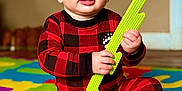 Austin joined the competition — help win amazing prizes! baby, child, indoor, pajamas, red_clothing, checkered_pattern, foam_mat, colorful, playtime, sitting, curious, hands, feet, toy, bright_colors, expression, face, floor, home, infant