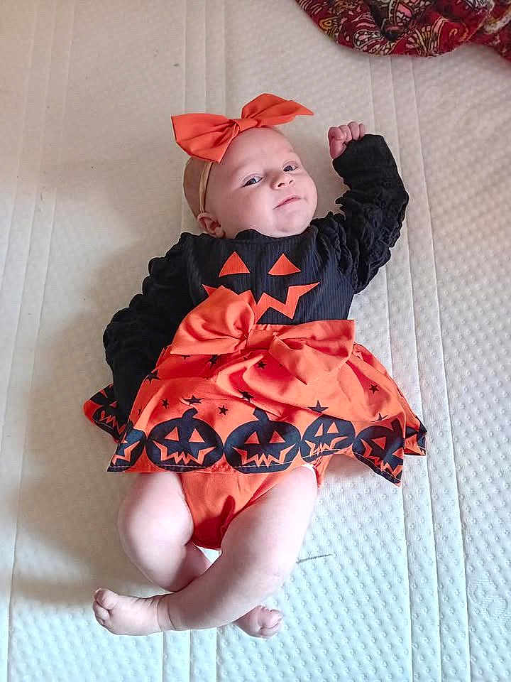 Anaé participe au concours pour gagner de l'argent avec cette photo : baby, infant, halloween, costume, orange, black, bow, headband, pumpkin, smile, lying, mattress, cute, child, holiday, celebration, clothing, indoors, person, toddler
