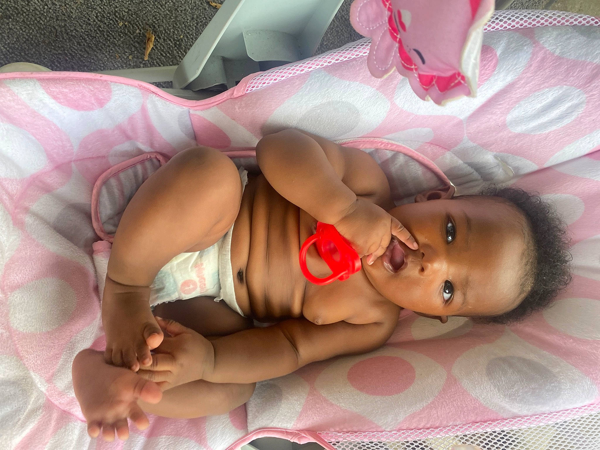 Jonesty is registered to the contest to win money with this photo: abdomen, baby, chest, comfort, finger, flesh, human_body, human_leg, knee, linens, mouth, nail, person, pink, skin, textile, thigh, toddler, toy, trunk