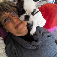 Max participe au concours pour gagner de l'argent avec cette photo : affection, black_and_white_dog, casual, closeup, couch, cozy, dog, face, furniture, glasses, happy, home, indoor, pet, portrait, relaxed, smiling, snuggle, sweater, woman