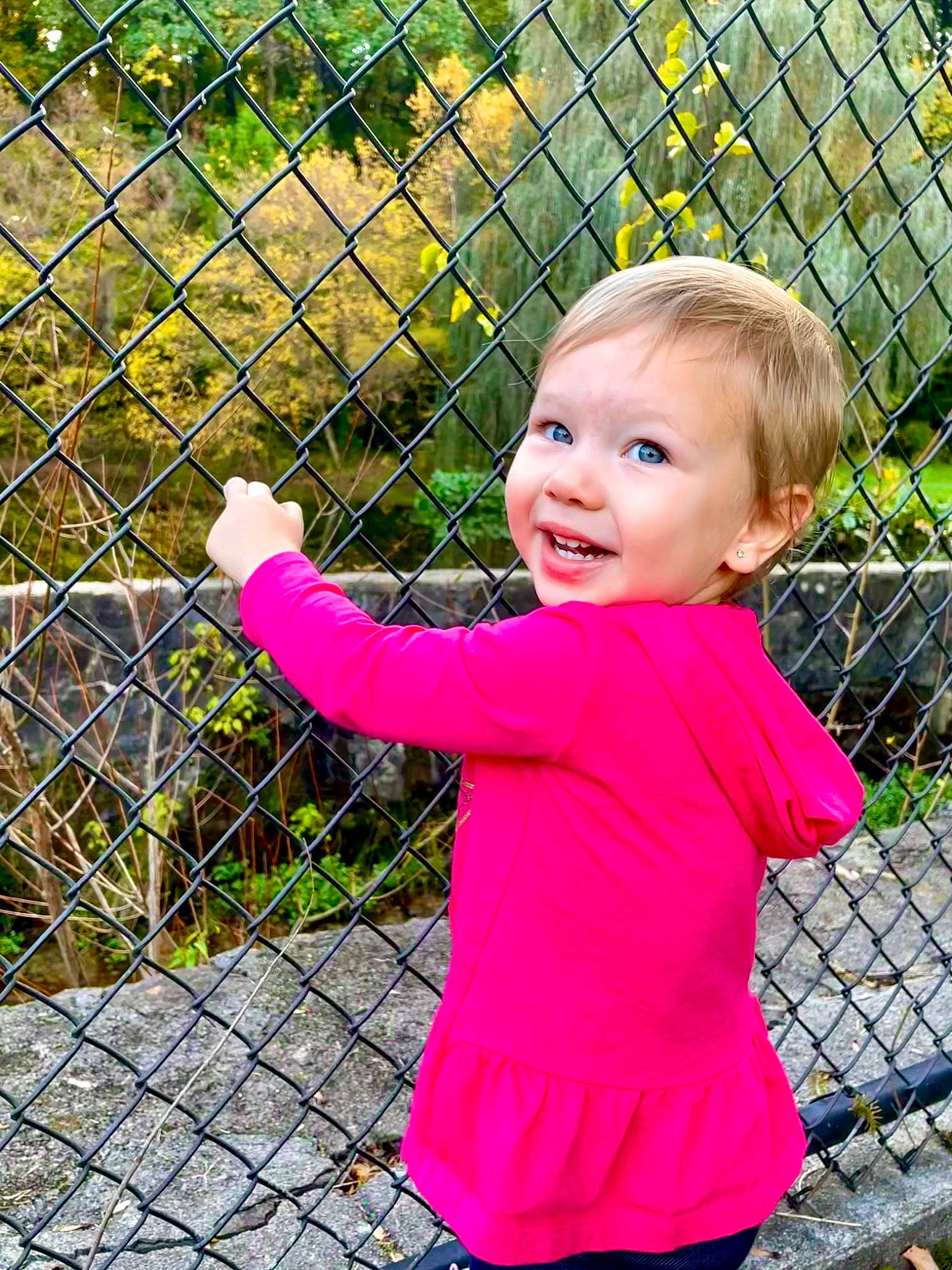 Kimberly is registered to the contest to win money with this photo: baby, baby_toddler_clothing, chain_link_fencing, fence, fun, grass, happy, joy, leaf, leisure, magenta, mesh, nose, people_in_nature, person, pink, plant, recreation, sleeve, smile