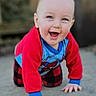 Gideon is registered to the contest to win money with this photo: baby, child, crawling, smiling, happy, outdoor, concrete, red_clothing, blue_clothing, spiderman, plaid_pants, person, face, hands, cute, infant, young_child, casual, daylight, portrait