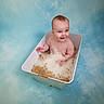 Gideon joined the competition — help win amazing prizes! baby, child, milk, cereal, tub, splashing, blue_background, happy, smiling, water, sitting, cute, infant, playful, indoors, food, milk_bath, person, face, fun