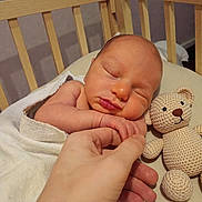 Gideon joined the competition — help win amazing prizes! newborn, baby, sleeping, crib, blanket, hand, finger, teddy_bear, knitted_toy, soft, cozy, peaceful, infant, child, cute, indoors, portrait, closeup, skin, resting