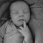 Alexis participe au concours pour gagner de l'argent avec cette photo : baby, newborn, infant, sleeping, face, finger, hand, onesie, striped_clothing, blanket, soft_texture, cozy, closeup, portrait, black_and_white, eyelashes, lips, nose, peaceful, swaddle