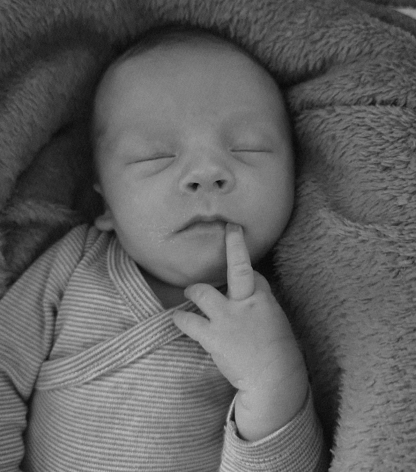 Alexis participe au concours pour gagner de l'argent avec cette photo : baby, newborn, infant, sleeping, face, finger, hand, onesie, striped_clothing, blanket, soft_texture, cozy, closeup, portrait, black_and_white, eyelashes, lips, nose, peaceful, swaddle