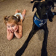 Jax joined the competition — help win amazing prizes! black_dog, blue_bandana, carpet, child, collar, companion, cute, dog, domestic_scene, eyes, face, girl, indoor, large_dog, living_room, lying_down, pet, pigtails, portrait, smiling