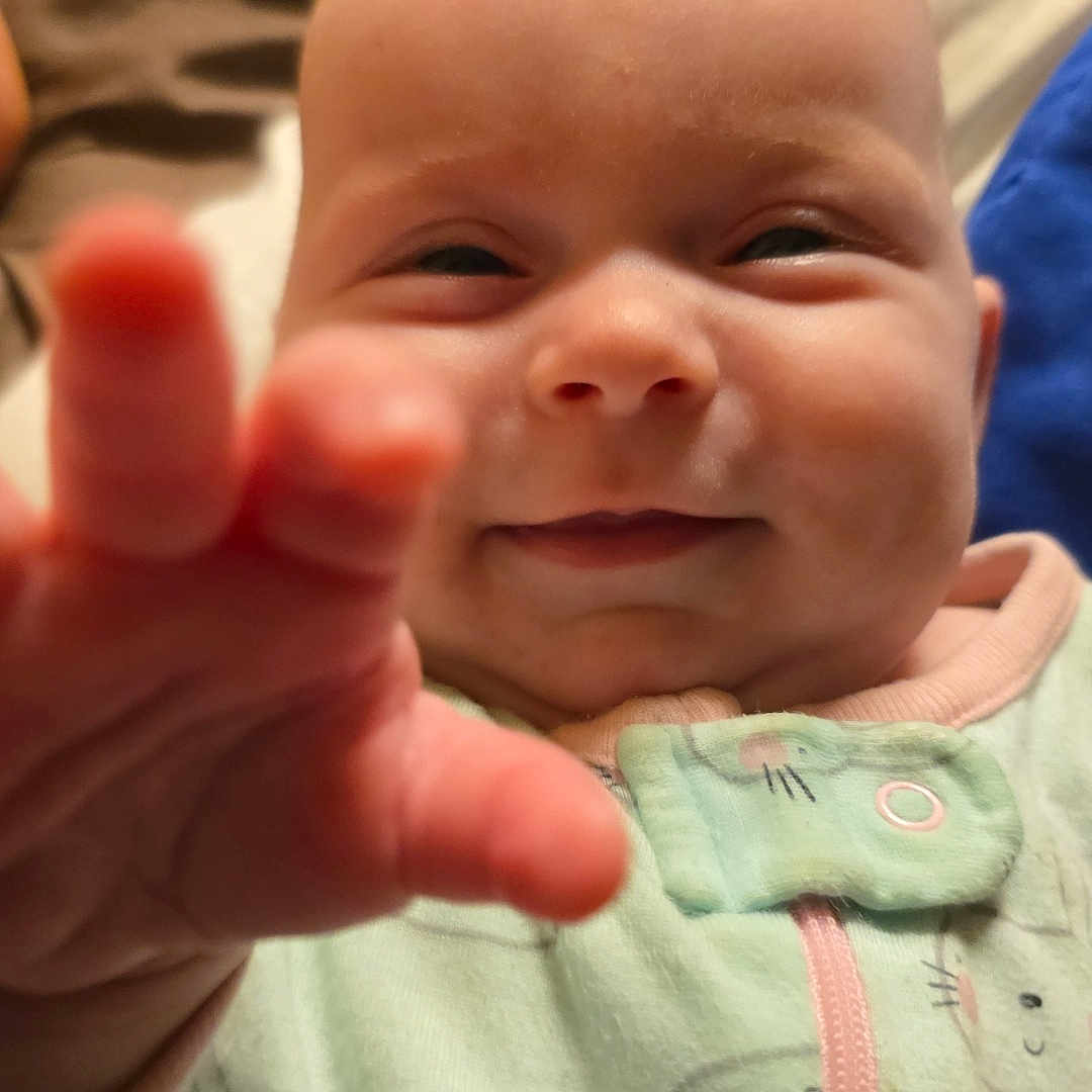 Carina is registered to the contest to win money with this photo: baby, bodypart, boy, child, face, finger, hand, happy, head, laughing, male, mouth, newborn, person, photography, portrait, quilt, smile, teeth, wrist