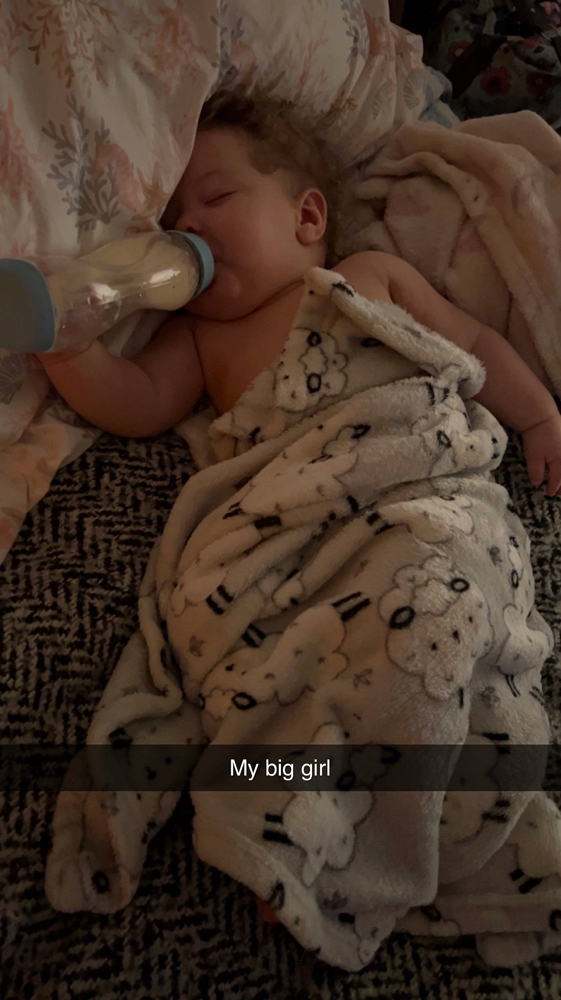 Aria is registered to the contest to win money with this photo: arm, baby, baby_bottle, baby_products, baby_safety, baby_toddler_clothing, bottle, child, comfort, drinkware, finger, linens, military_camouflage, mouth, pattern, person, plastic_bottle, skin, sleeve, thumb