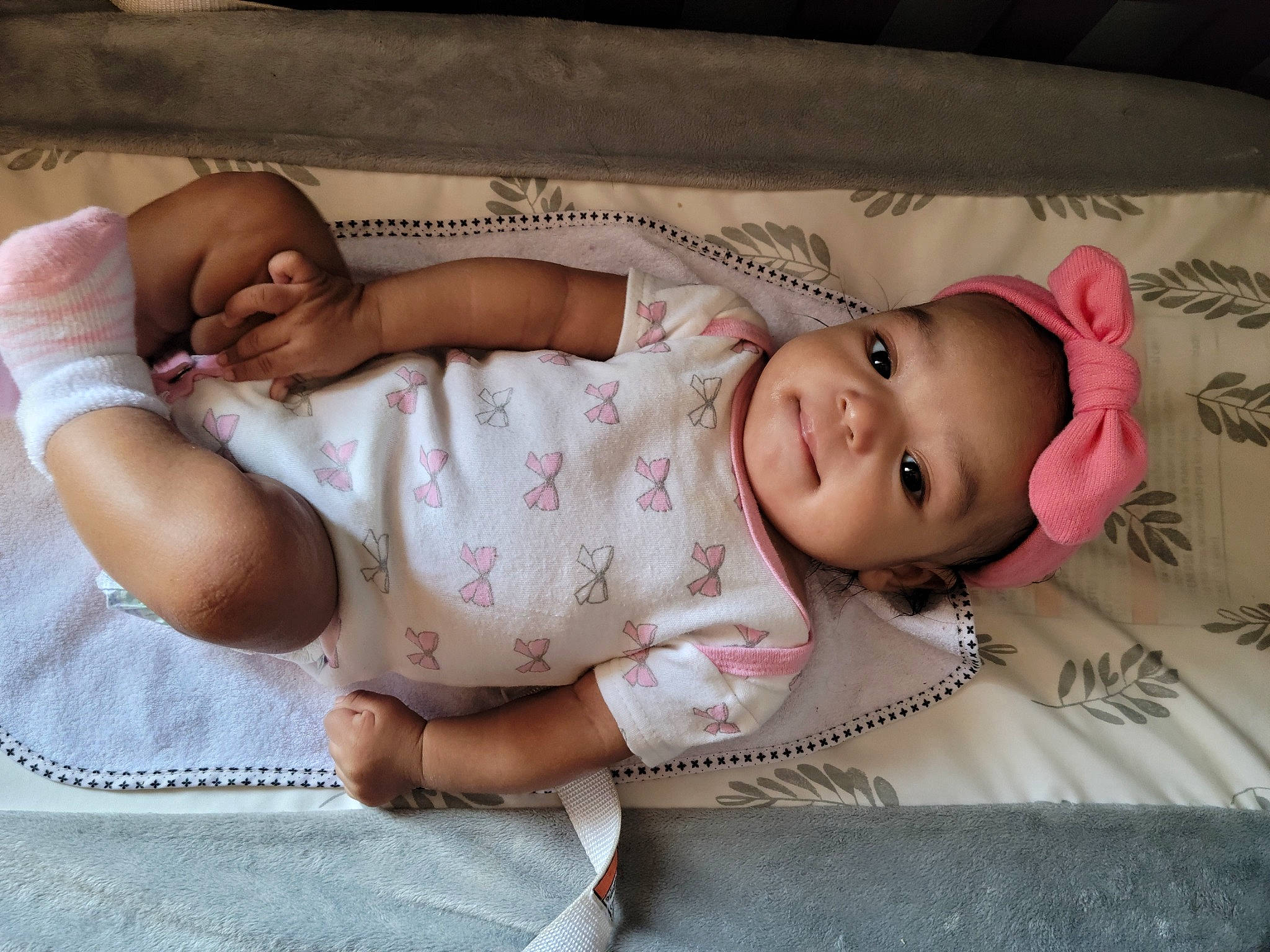 Rosalind is registered to the contest to win money with this photo: baby, baby_toddler_clothing, cheek, child, comfort, face, facial_expression, happy, headwear, linens, lip, mammal, mouth, person, pink, product, skin, sleeve, smile, stomach