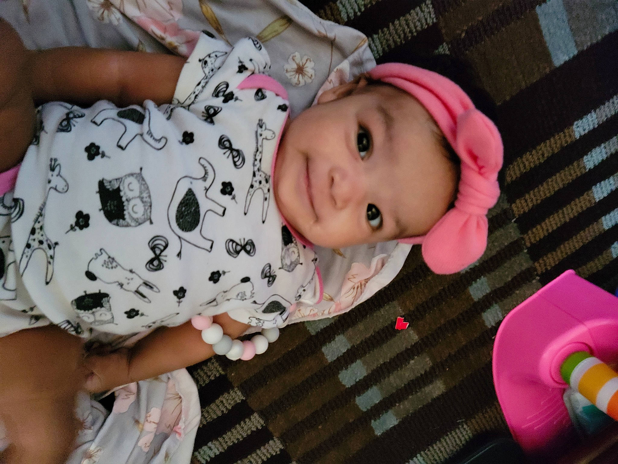 Rosalind is registered to the contest to win money with this photo: baby, baby_products, baby_safety, baby_toddler_clothing, cheek, child, comfort, headwear, human_body, iris, joy, lip, nose, pattern, person, pink, skin, sleeve, smile, textile