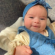 Rachel participe au concours pour gagner de l'argent avec cette photo : baby, child, denim, headband, vest, smile, fist, blanket, soft, cozy, clothing, infant, cute, portrait, face, person, apparel, indoors, light, fabric