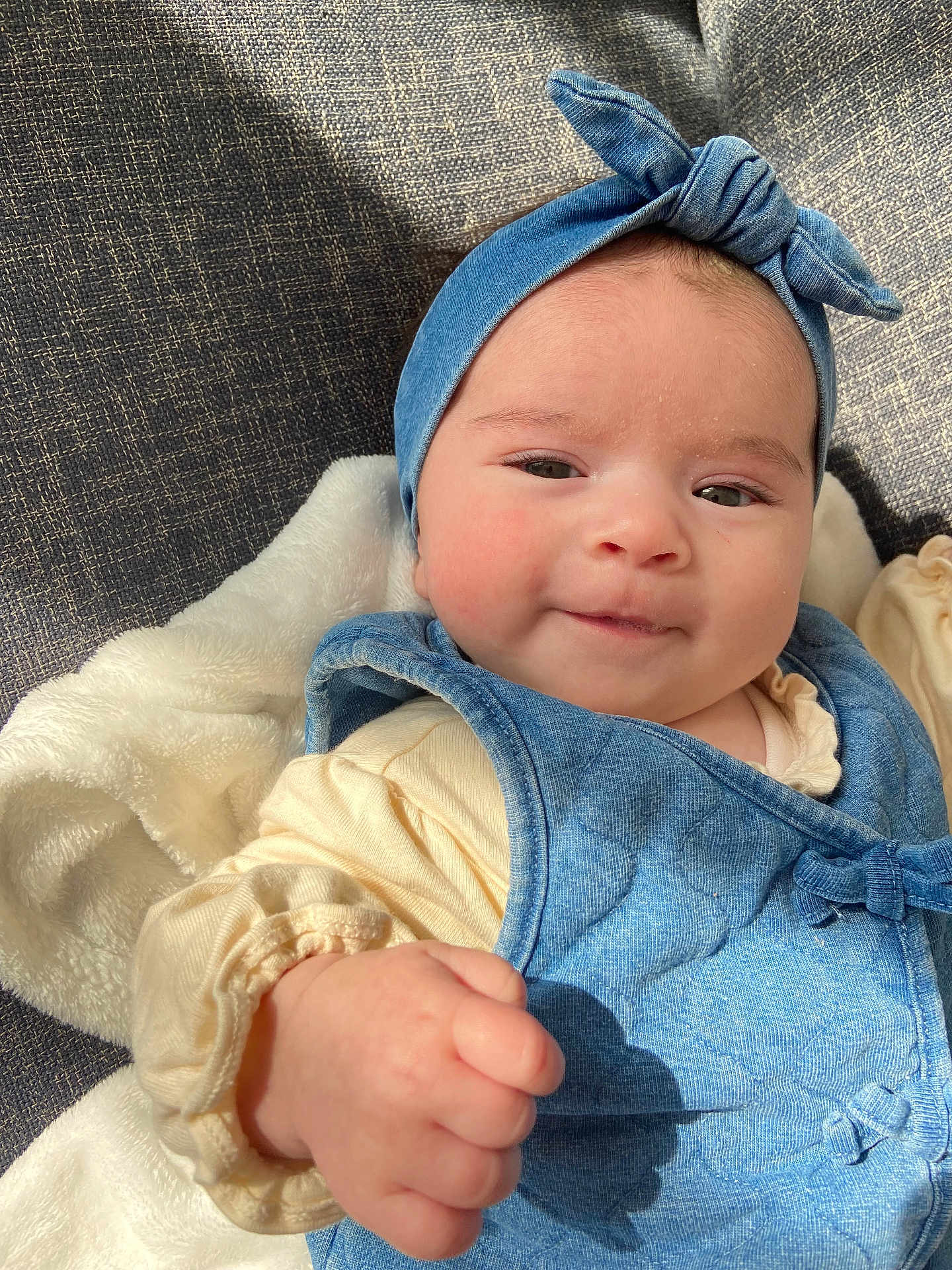 Rachel participe au concours pour gagner de l'argent avec cette photo : baby, child, denim, headband, vest, smile, fist, blanket, soft, cozy, clothing, infant, cute, portrait, face, person, apparel, indoors, light, fabric