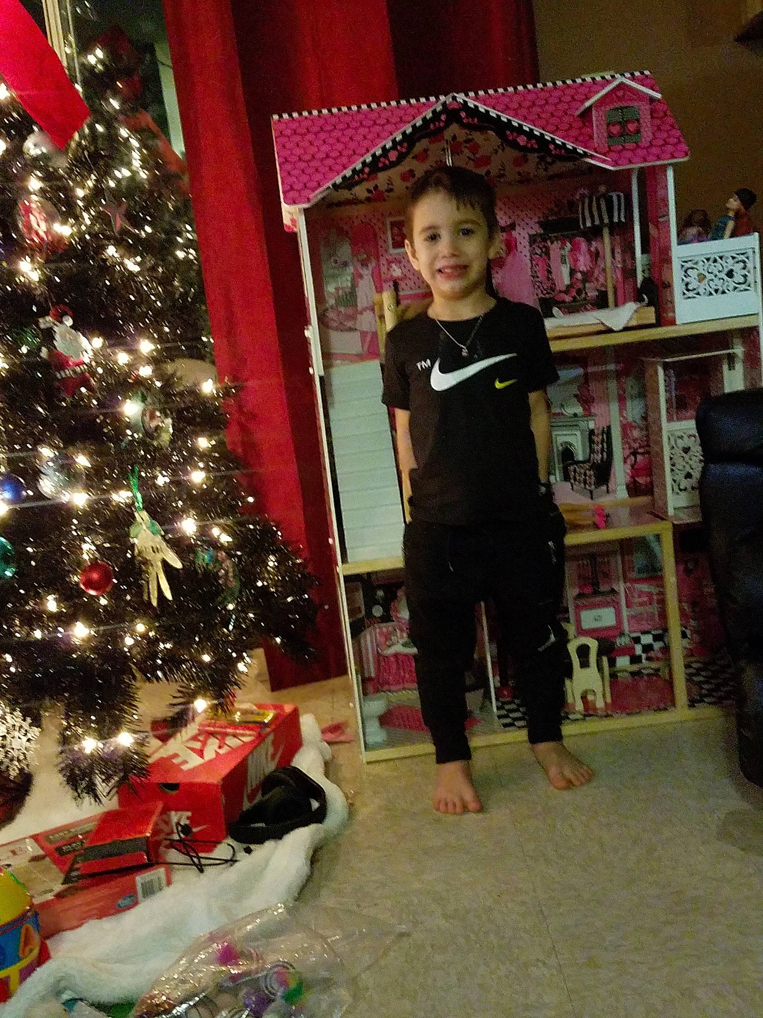 Jeffrey is registered to the contest to win money with this photo: child, christmas, christmas_decoration, christmas_eve, christmas_lights, christmas_ornament, christmas_tree, event, fictional_character, fir, holiday, home, interior_design, joy, person, plant, room, standing, toddler, tree