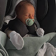 Desmond joined the competition — help win amazing prizes! newborn, baby, sleeping, car_seat, pacifier, blanket, mittens, infant, cozy, resting, cute, child, headwear, soft, knit, peaceful, indoors, portrait, wrapped, calm