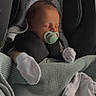 newborn, baby, sleeping, car_seat, pacifier, blanket, mittens, infant, cozy, resting, cute, child, headwear, soft, knit, peaceful, indoors, portrait, wrapped, calm