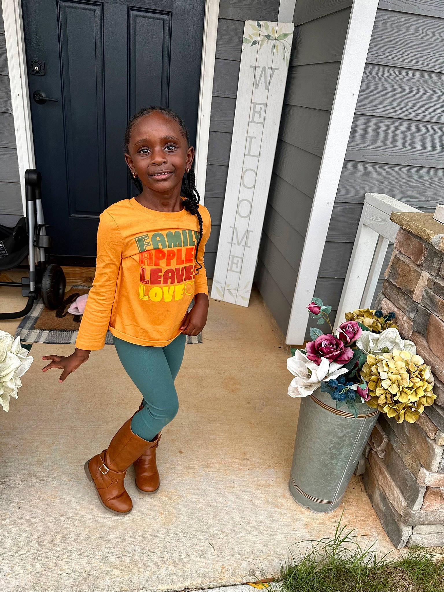 Elena is registered to the contest to win money with this photo: child, denim, door, flooring, flower, flowerpot, fun, happy, home_door, house, joy, leisure, orange, people, person, plant, sandal, smile, t_shirt, toddler