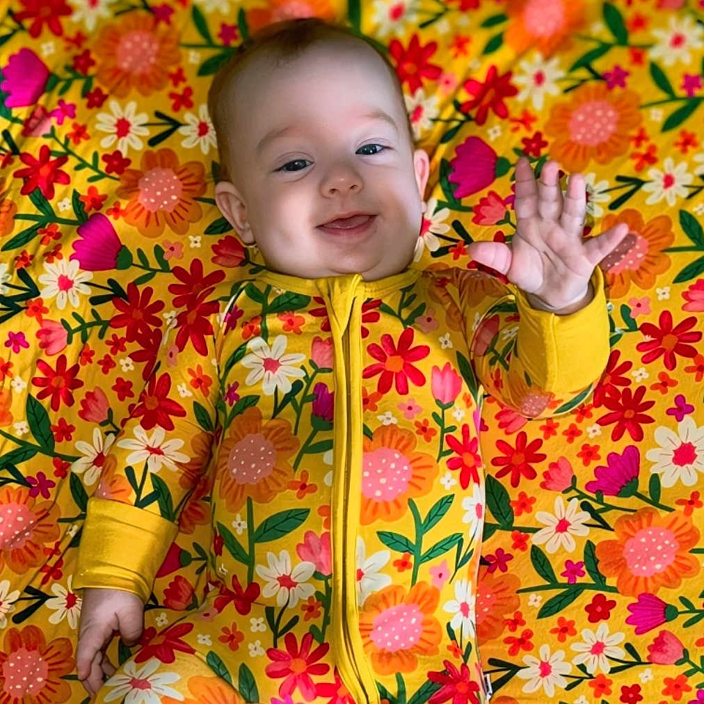 Avery is registered to the contest to win money with this photo: baby, babylaughing, bodypart, clothing, coat, dress, face, finger, hand, happy, head, jacket, laughing, leaf, person, photography, plant, portrait, quilt, smile