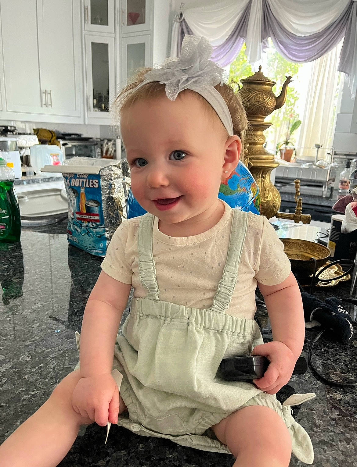 Thena is registered to the contest to win money with this photo: baby, baby_toddler_clothing, chair, child, curtain, event, fashion_accessory, flooring, fun, hairstyle, happy, human_leg, joy, person, pink, shorts, sitting, skin, smile, standing