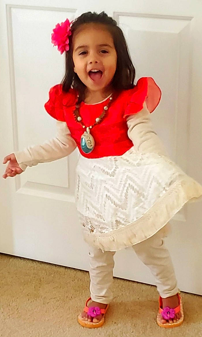 Cyara is registered to the contest to win money with this photo: baby_toddler_clothing, child, clothing, collar, dress, event, facial_expression, fashion_accessory, flower, happy, human_leg, magenta, outerwear, pattern, person, pink, shoulder, sleeve, smile, toddler