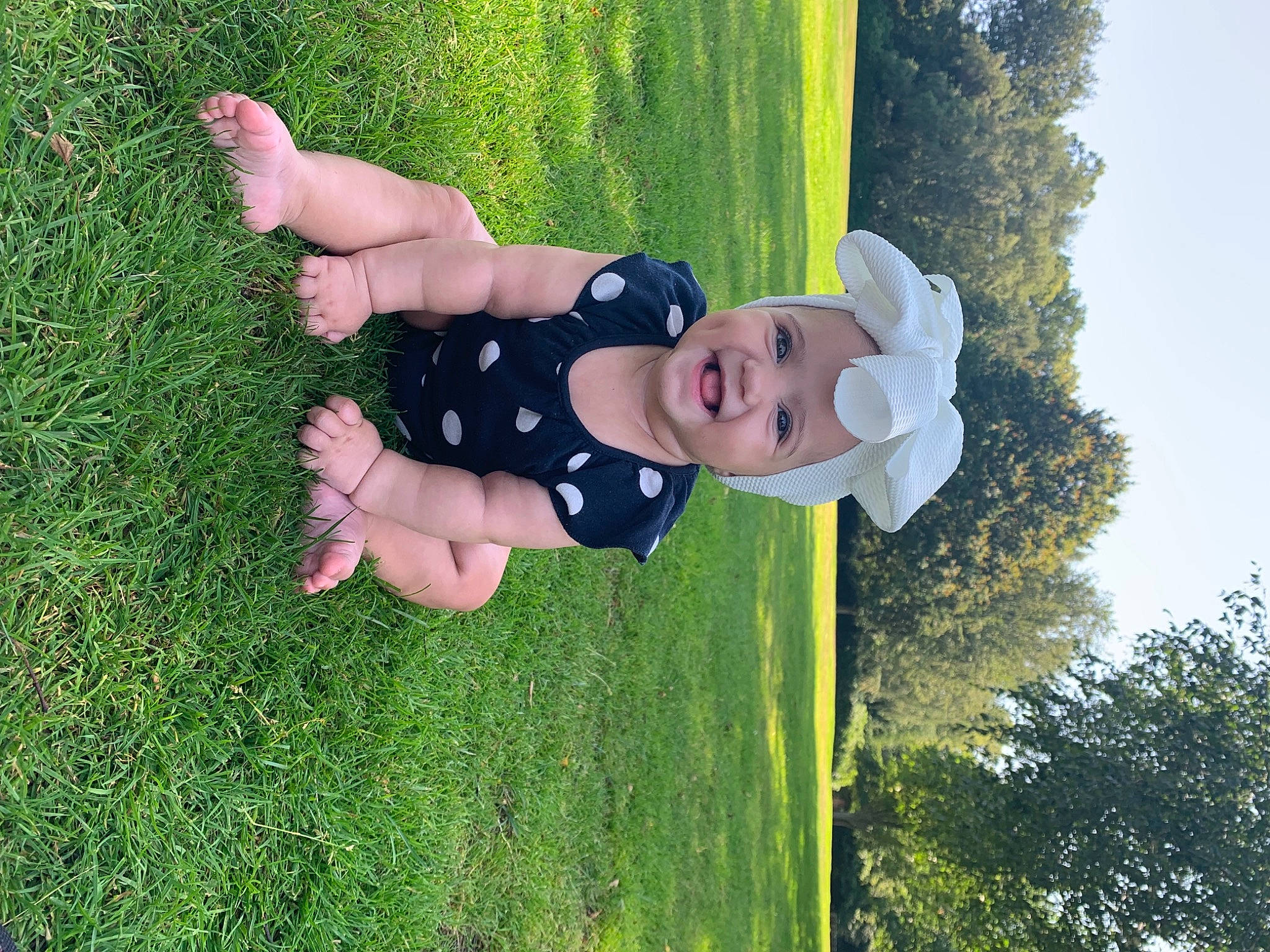 Melody is registered to the contest to win money with this photo: baby, baby_toddler_clothing, child, fun, grass, grassland, green, happy, headwear, lawn, leisure, meadow, people_in_nature, person, plant, recreation, sky, smile, spring, thigh